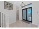 Bright foyer has modern lighting, elegant decor, and double doors leading to the outside at 882 Bay Point Dr, Madeira Beach, FL 33708