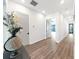 Hallway with wood flooring, white walls, and views to the bedroom and living room at 882 Bay Point Dr, Madeira Beach, FL 33708