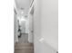 Hallway featuring wood floors and white walls with doors and pot lights at 882 Bay Point Dr, Madeira Beach, FL 33708