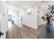 Hallway with views to the bedrooms with waterfront views, wood flooring, and white walls at 882 Bay Point Dr, Madeira Beach, FL 33708