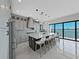 Spacious kitchen with stainless steel appliances, a large center island, and a view of the water at 882 Bay Point Dr, Madeira Beach, FL 33708