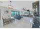 Elegant living room and dining area with a glass table, blue sofa, and modern entertainment center at 882 Bay Point Dr, Madeira Beach, FL 33708