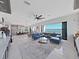 Bright living room featuring an open floor plan, sleek blue sectional, and breathtaking water views at 882 Bay Point Dr, Madeira Beach, FL 33708