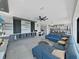 Spacious living area with a comfortable blue sofa, custom built-ins, and a contemporary design at 882 Bay Point Dr, Madeira Beach, FL 33708