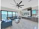 Bright living room featuring a stylish sectional sofa, modern entertainment center, and stunning water views at 882 Bay Point Dr, Madeira Beach, FL 33708