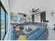 Cozy living room featuring a modern sectional sofa, built-in cabinetry, and scenic water views at 882 Bay Point Dr, Madeira Beach, FL 33708