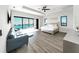 Spacious bedroom with water views, wood flooring, and a comfortable seating area at 882 Bay Point Dr, Madeira Beach, FL 33708