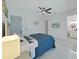 Main bedroom with a television, ceiling fan, and access to an ensuite at 882 Bay Point Dr, Madeira Beach, FL 33708