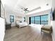 Spacious main bedroom with water views, sitting area, and tray ceiling at 882 Bay Point Dr, Madeira Beach, FL 33708