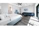 Inviting bedroom featuring water views, sleek wood floors, and a stylish seating area at 882 Bay Point Dr, Madeira Beach, FL 33708