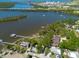 Stunning aerial view of waterfront homes, private docks, and tranquil bay waters with views of the distant city at 8820 S Hickory Ln, Riverview, FL 33578