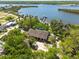 Expansive aerial shot showcasing a waterfront property, lush landscaping, and stunning water views with private docks at 8820 S Hickory Ln, Riverview, FL 33578