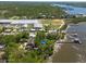 Panoramic aerial view of a vibrant waterfront community with residential homes, boat docks, and beautiful coastal views at 8820 S Hickory Ln, Riverview, FL 33578