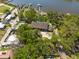 Aerial shot of a stunning waterfront estate, lush landscaping, and private docks for enjoying waterfront living at its finest at 8820 S Hickory Ln, Riverview, FL 33578
