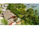 Aerial view of home with mature trees, lush landscaping, and expansive waterfront at 8820 S Hickory Ln, Riverview, FL 33578