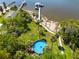 Aerial view of backyard with pool, deck, walkway to dock on the waterfront at 8820 S Hickory Ln, Riverview, FL 33578