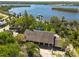 Expansive aerial shot showcasing a waterfront property, lush landscaping, and stunning water views with private docks at 8820 S Hickory Ln, Riverview, FL 33578