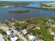 Panoramic aerial view of waterfront houses along bay waters with docks and views of the distant city at 8820 S Hickory Ln, Riverview, FL 33578