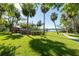 Backyard featuring an above-ground pool, lush lawn, mature trees, and a view of the waterway at 8820 S Hickory Ln, Riverview, FL 33578