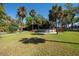 Expansive backyard with above ground pool and lush tropical landscaping at 8820 S Hickory Ln, Riverview, FL 33578