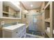 Bathroom featuring a tiled shower with glass enclosure and a single vanity at 8820 S Hickory Ln, Riverview, FL 33578