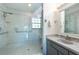 Bathroom featuring a tiled shower with glass enclosure and a single vanity at 8820 S Hickory Ln, Riverview, FL 33578