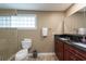 Bathroom featuring a double vanity with granite top, glass shower, and modern fixtures at 8820 S Hickory Ln, Riverview, FL 33578