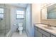Bright bathroom features tile floors, a walk-in shower, and a vanity with marble countertops at 8820 S Hickory Ln, Riverview, FL 33578