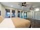 Bedroom with view to porch offering natural light and ceiling fans at 8820 S Hickory Ln, Riverview, FL 33578
