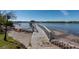 Wooden dock and walkway offer picturesque water views, an inviting spot for relaxation, recreation and stunning scenery at 8820 S Hickory Ln, Riverview, FL 33578