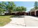 Exterior view showcasing an expansive driveway and mature tree coverage at 8820 S Hickory Ln, Riverview, FL 33578