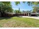 Front lawn of home with garage and circular driveway, manicured landscaping at 8820 S Hickory Ln, Riverview, FL 33578