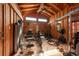 Spacious home gym featuring wood paneled walls, a ceiling fan, and an array of exercise equipment at 8820 S Hickory Ln, Riverview, FL 33578