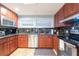 Well-appointed kitchen with stainless appliances, granite countertops, and warm wood cabinetry at 8820 S Hickory Ln, Riverview, FL 33578