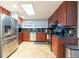 Spacious kitchen with stainless steel refrigerator, granite countertops, and ample cabinet space at 8820 S Hickory Ln, Riverview, FL 33578