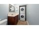 Convenient laundry area with stacked washer and dryer, sink, and cabinet space at 8820 S Hickory Ln, Riverview, FL 33578