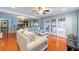 Open living space with wood floors and sliding doors to a porch, next to the kitchen and laundry at 8820 S Hickory Ln, Riverview, FL 33578