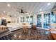 Bright living room featuring ample windows, neutral colors, and modern ceiling fans at 8820 S Hickory Ln, Riverview, FL 33578