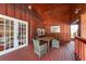 Cozy outdoor patio with wood walls, flooring, and furniture, perfect for relaxing or dining at 8820 S Hickory Ln, Riverview, FL 33578