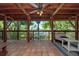 Inviting outdoor porch with wood ceiling and tiled flooring overlooks a view of the water at 8820 S Hickory Ln, Riverview, FL 33578