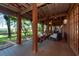 Relaxing screened-in porch with a swing, comfortable seating, and views of the lush landscape at 8820 S Hickory Ln, Riverview, FL 33578