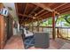 Inviting outdoor porch with wood floors and cozy seating offers water views at 8820 S Hickory Ln, Riverview, FL 33578