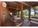 Inviting porch with ample seating and wood floors offers views of the lush green landscape at 8820 S Hickory Ln, Riverview, FL 33578