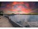 Beautiful waterfront view at sunset, showcasing the serene waters and a well-maintained walkway at 8820 S Hickory Ln, Riverview, FL 33578