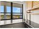 Balcony with beautiful city and ocean views with black-tiled flooring and white columns at 9415 Blind Pass Rd # 704, St Pete Beach, FL 33706