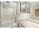 Functional bathroom with a shower-tub combo, toilet and vanity with a large mirror at 9415 Blind Pass Rd # 704, St Pete Beach, FL 33706