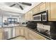 Modern kitchen featuring stone countertops, stainless steel appliances, and ample cabinet space for culinary enthusiasts at 9415 Blind Pass Rd # 704, St Pete Beach, FL 33706