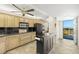 Modern kitchen features stainless steel appliances, ample cabinetry, and easy access to a balcony with beautiful views at 9415 Blind Pass Rd # 704, St Pete Beach, FL 33706