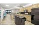 Spacious kitchen with modern appliances, breakfast bar, and open layout flowing into the living area and balcony at 9415 Blind Pass Rd # 704, St Pete Beach, FL 33706