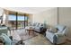 Inviting living room features cozy seating, stylish decor, and sliding glass doors to balcony with beautiful views at 9415 Blind Pass Rd # 704, St Pete Beach, FL 33706
